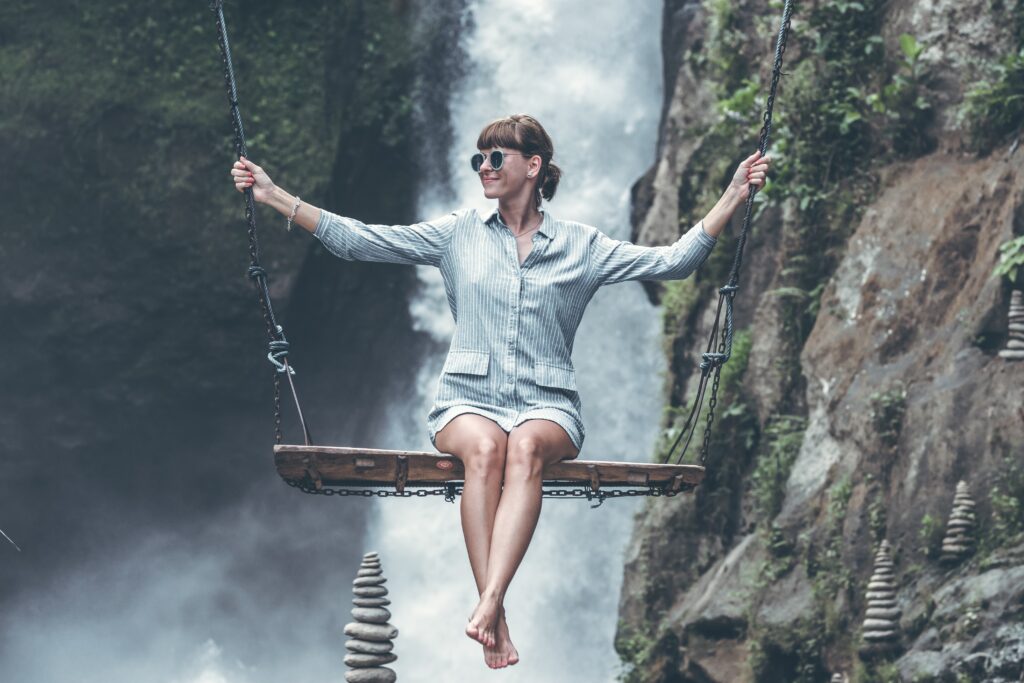 Photo Of Woman Riding Swing In Front Of Waterfalls 1160131